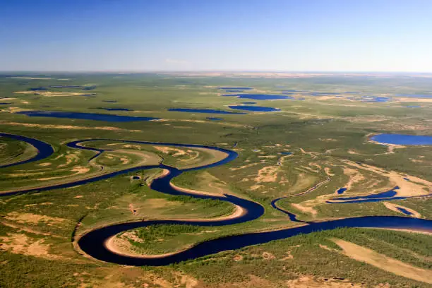 Nature of the Northern tundra of the Taimyr Peninsula view from a helicopter. Rivers, lakes and swamps in the Arctic tundra of Siberia.