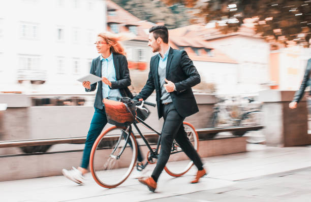 istock Two business people commuting by bicycles 1209028892