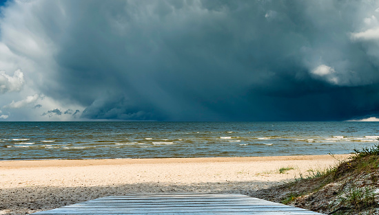 Sandy beach of the Baltic Sea and approaching thunderstorm