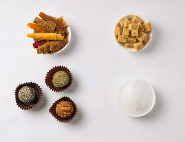 sugar-free sweets concept. on a white background on one side healthy candies of dried fruits on the other sugar