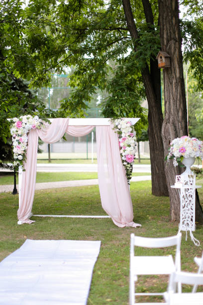 istock Wedding arch and chairs in garden 1209029533