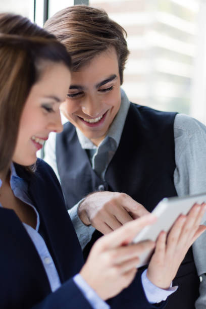 istock Two young business persons relaxed at the office 1209030729