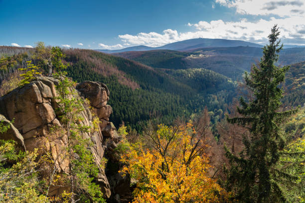 The Rabenklippe, granite rock in the Harz National Park The Rabenklippe near Bad Harzburg. Granite rock in the Harz National Park. View to the Brocken under blue sky with some clouds in autumn. lower saxony stock pictures, royalty-free photos & images