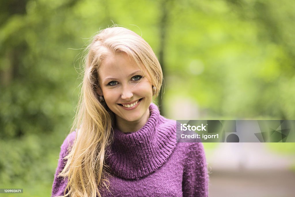 woman in park. The young smiling woman in park. Adult Stock Photo