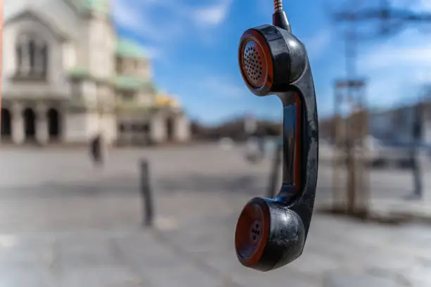 Photo of Handphone hanging in telephone booth in front of Alexander Nevski cathedral in Sofia, Bulgaria