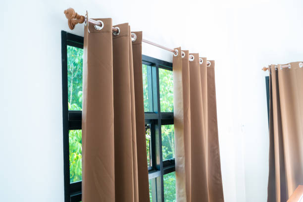 istock Beige curtain in cozy white bedroom 1209035474