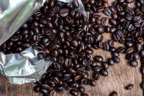 istock Arabica roast coffee bean spread on wood table 1209036855
