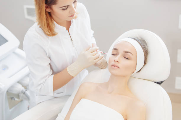 istock Cosmetologist doing a syringe beauty shots. 1209039321