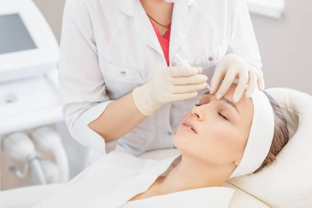 istock Cosmetologist doing a syringe beauty shots. 1209040232