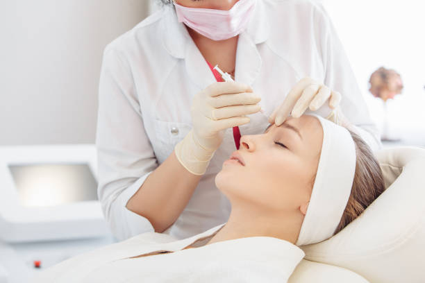 istock Cosmetologist doing a syringe beauty shots. 1209040281