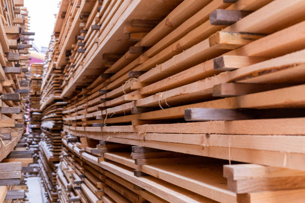 istock large stacks of wooden planks background with selective focus and linear perspective. Winter oudoor storage. 1209041101