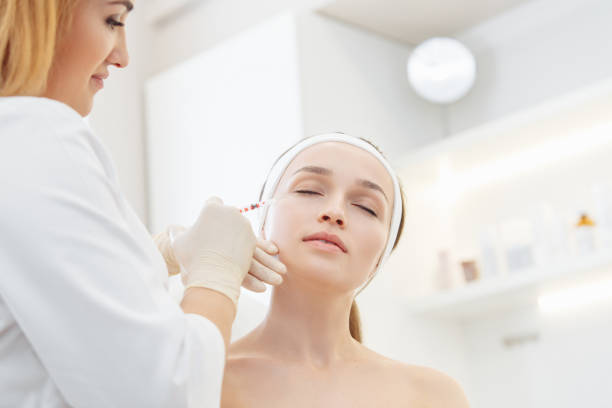 istock Cosmetologist doing a syringe beauty shots. 1209041193