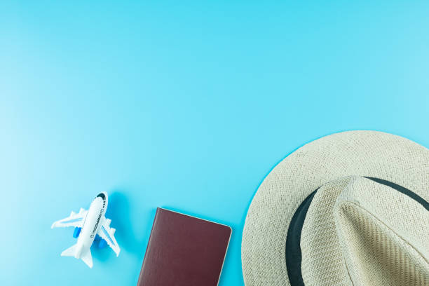 istock Top view Hat, Passport and Plane model on blue background with copy space for text. Travel and Vacation concept 1209041262
