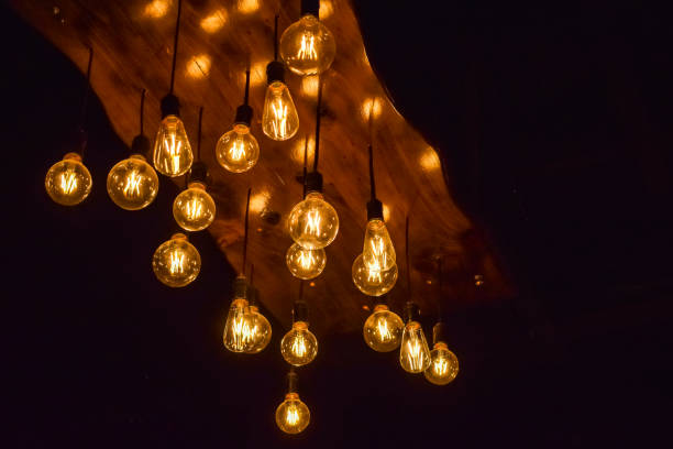 istock Vintage glowing light bulbs under ceiling as a decoration 1209041430