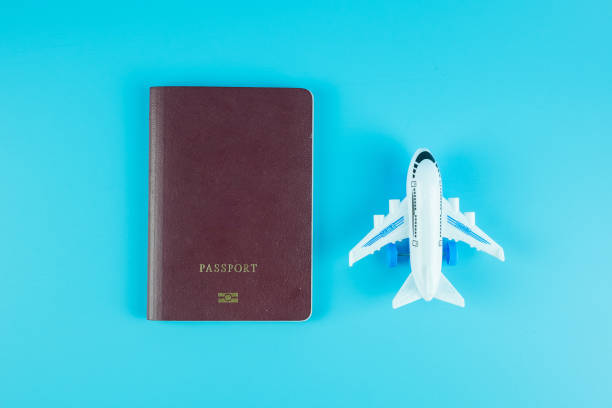 istock Top view passport and  airplane model on blue background with copy space for text 1209041449