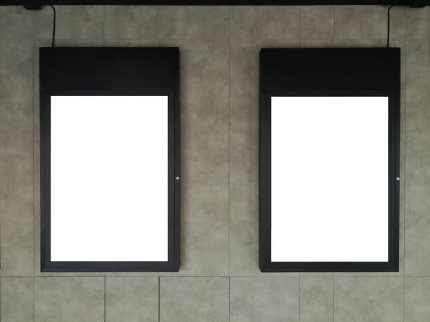 istock Two Black frame advertising signs with white background on bare cement or concrete wall 1209041779