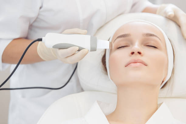 istock cosmetologist do microcurrent on the face of a girl client 1209041874