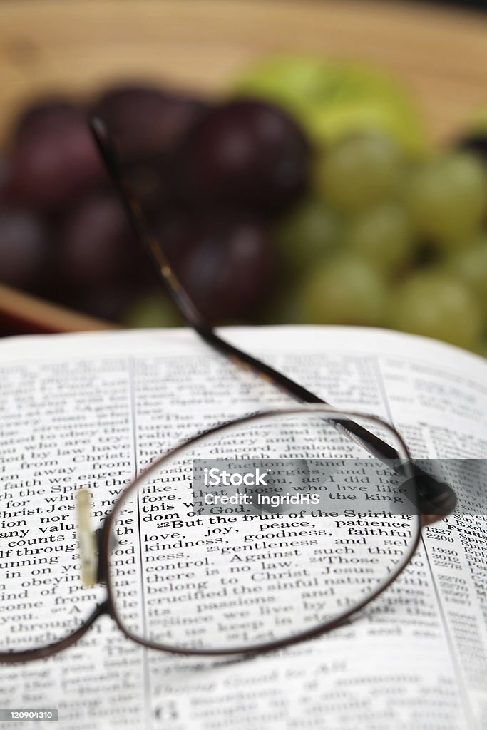 Fruit of the spirit Holy Bible open to Galatians 5. Focus on verse 22.  Apple - Fruit Stock Photo