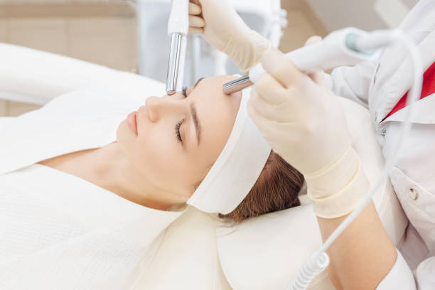 istock cosmetologist do microcurrent on the face of a girl client 1209043198