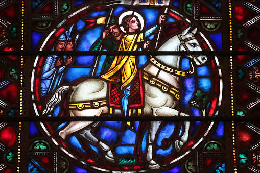 United States. North America. USA. New York. 11/24/2012. This colorful image depicts stained-glass windows by Hildreth Meiere. (1892-1961). Joan of Arc on a horse. St. Bartholomew's Episcopal Church. St. Bartholomew's Church, commonly called St. Bart's, is a historic Episcopal parish founded in January 1835.