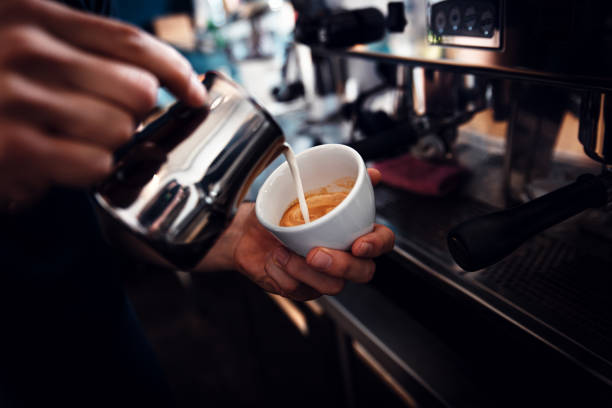 istock Close up of barista hands preparing cappuccino. 1209043368