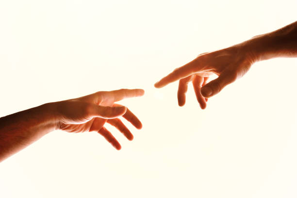 Two hands with fingers that almost touch isolated white Two hands with fingers that almost touch. Representation of the Christian concept of the creation of man on earth. Horizontal composition origins stock pictures, royalty-free photos & images