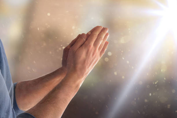 istock Man praying in church with hands with palms together flash 1209045179