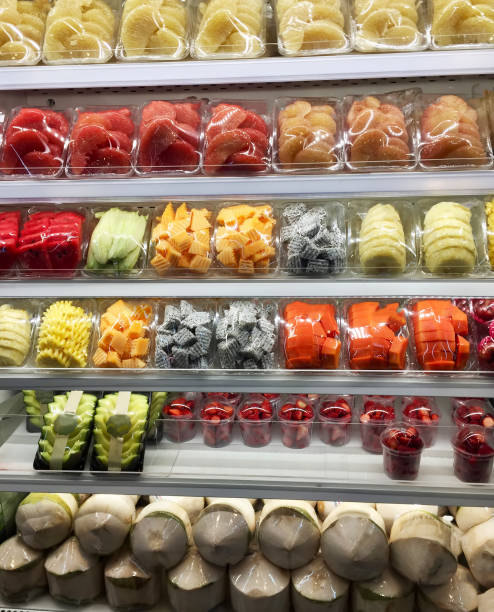 istock cutting tropical fruits in containers in a display 1209045812