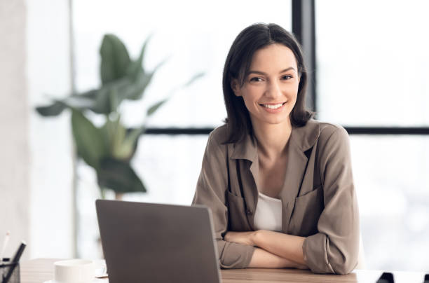 istock Happy young manager smiling at camera in her office 1209047760