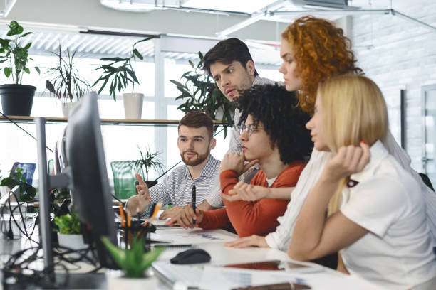 istock Fatigued group of young employees looking for business solution 1209047776