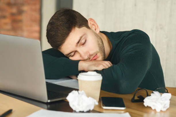 istock Exhausted Man Sleeping At Laptop Sitting In Office 1209047795