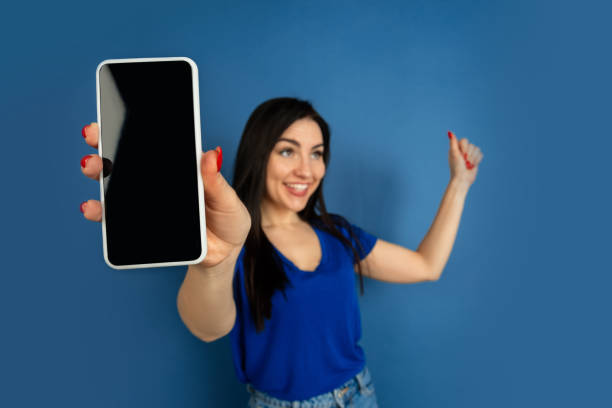 istock Caucasian woman's portrait isolated on blue studio background 1209047848