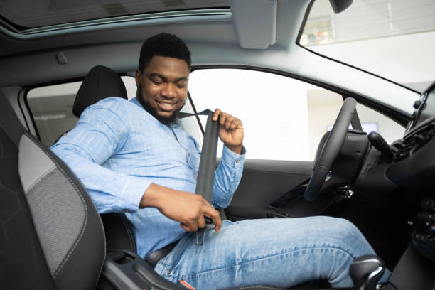 istock African American Man Putting On Seat Belt Sitting In Auto 1209048370