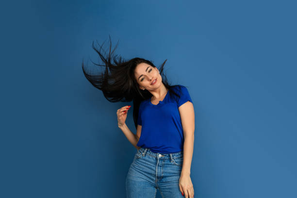 istock Caucasian woman's portrait isolated on blue studio background 1209048946