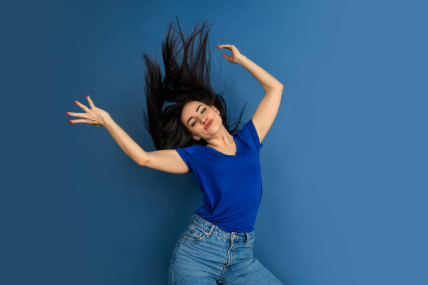 istock Caucasian woman's portrait isolated on blue studio background 1209048970