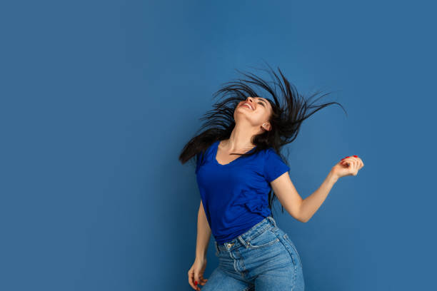 istock Caucasian woman's portrait isolated on blue studio background 1209048973