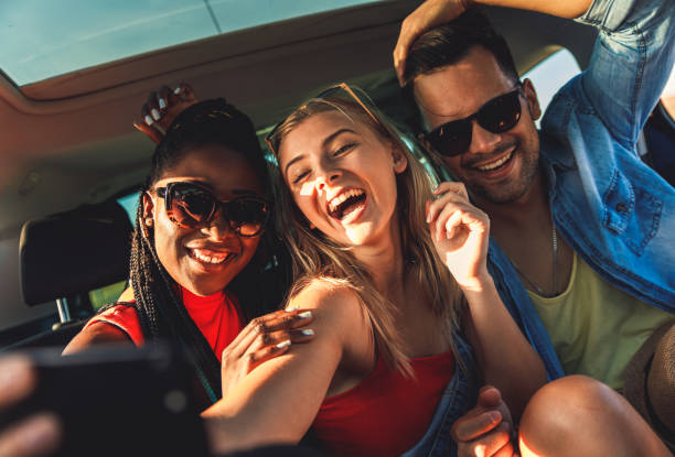 istock Three best friends enjoying traveling in the car. 1209049111