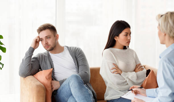istock Multiracial Couple After Quarrel Not Talking Sitting In Psychologist's Office 1209053054