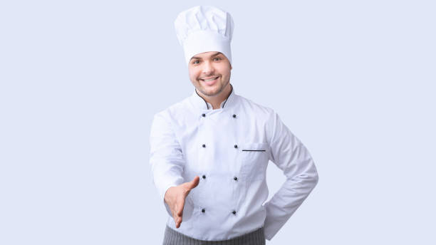 istock Chef Stretching Hand For Handshake Greeting Standing, White Background, Panorama 1209053975