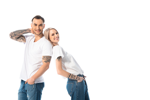happy young tattooed couple isolated on white