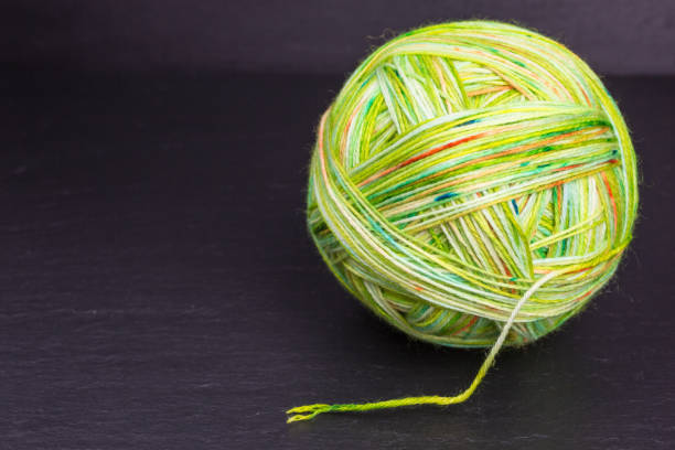 istock ball of multicolored green wool 1209055226