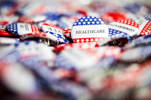 Election Vote Buttons - Healthcare Closeup of election vote button with text that says Healthcare midterm election photos stock pictures, royalty-free photos & images