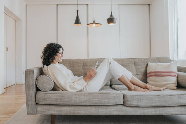 istock Woman sitting on the sofa 1209056833