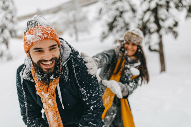 istock Couple in the snow playing 1209057299