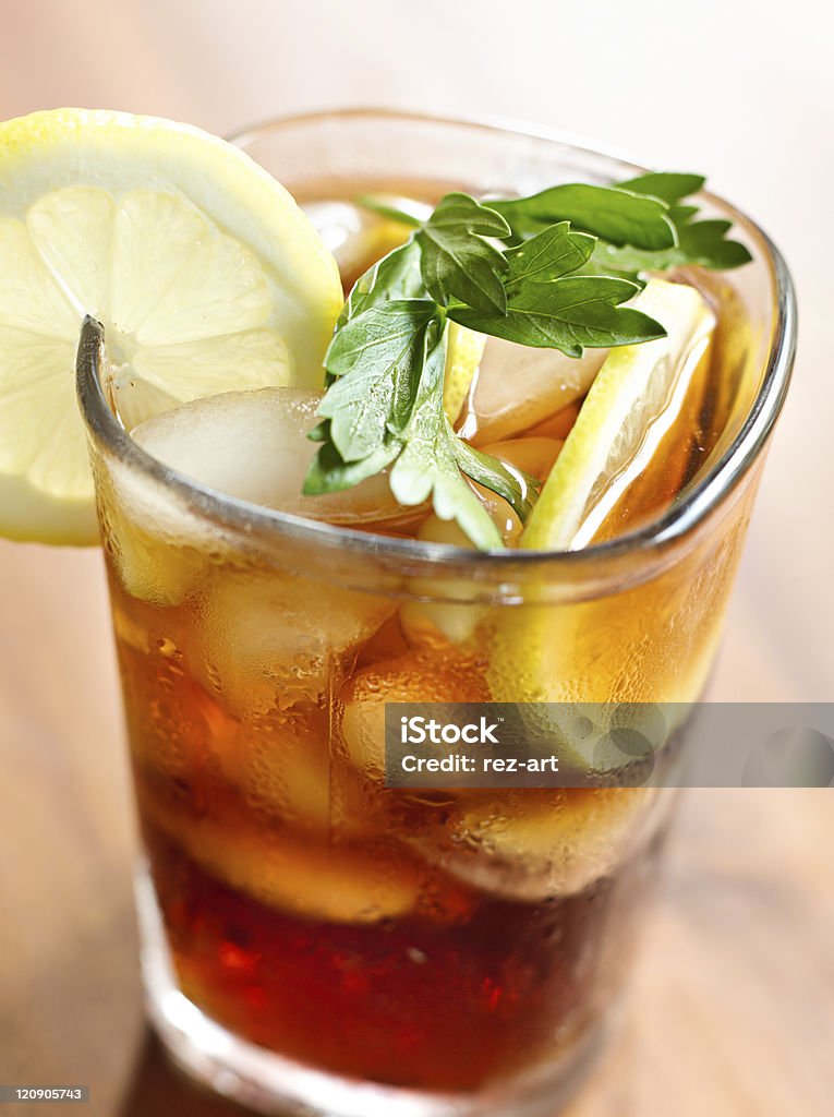 iced tea with lemon slice and leaf garnish. closeup photo of iced tea with lemon slice and leaf garnish. Selective focus on garnish. Shot on a leaf aptus digital back. Cold Temperature Stock Photo