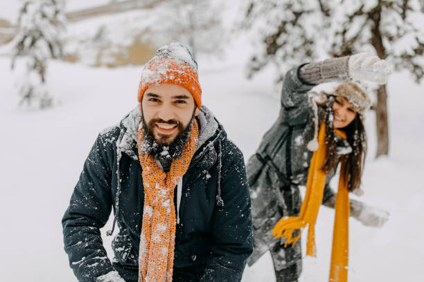 istock Couple in the snow playing 1209057971