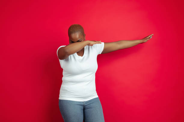 istock African-american young woman's portrait on red background 1209058186