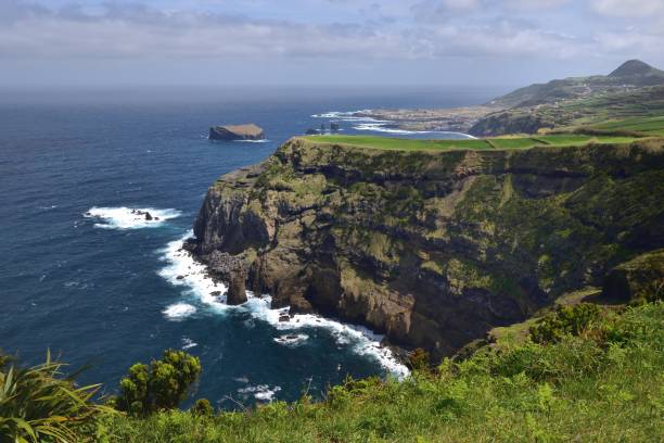 istock Waves crashing into the base of the sea cliffs 1209058740
