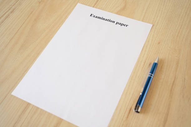 istock Empty examination paper for university with pen on the school desk. Copyspace. Mockup. Flat lay 1209062664
