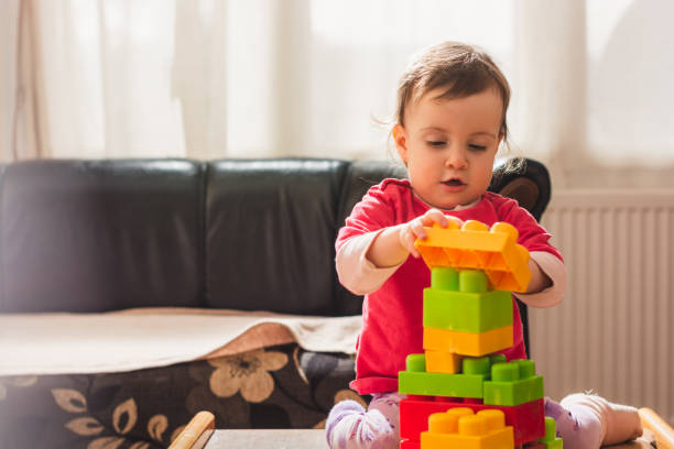 istock Small girl playing with plastic blocks 1209063173